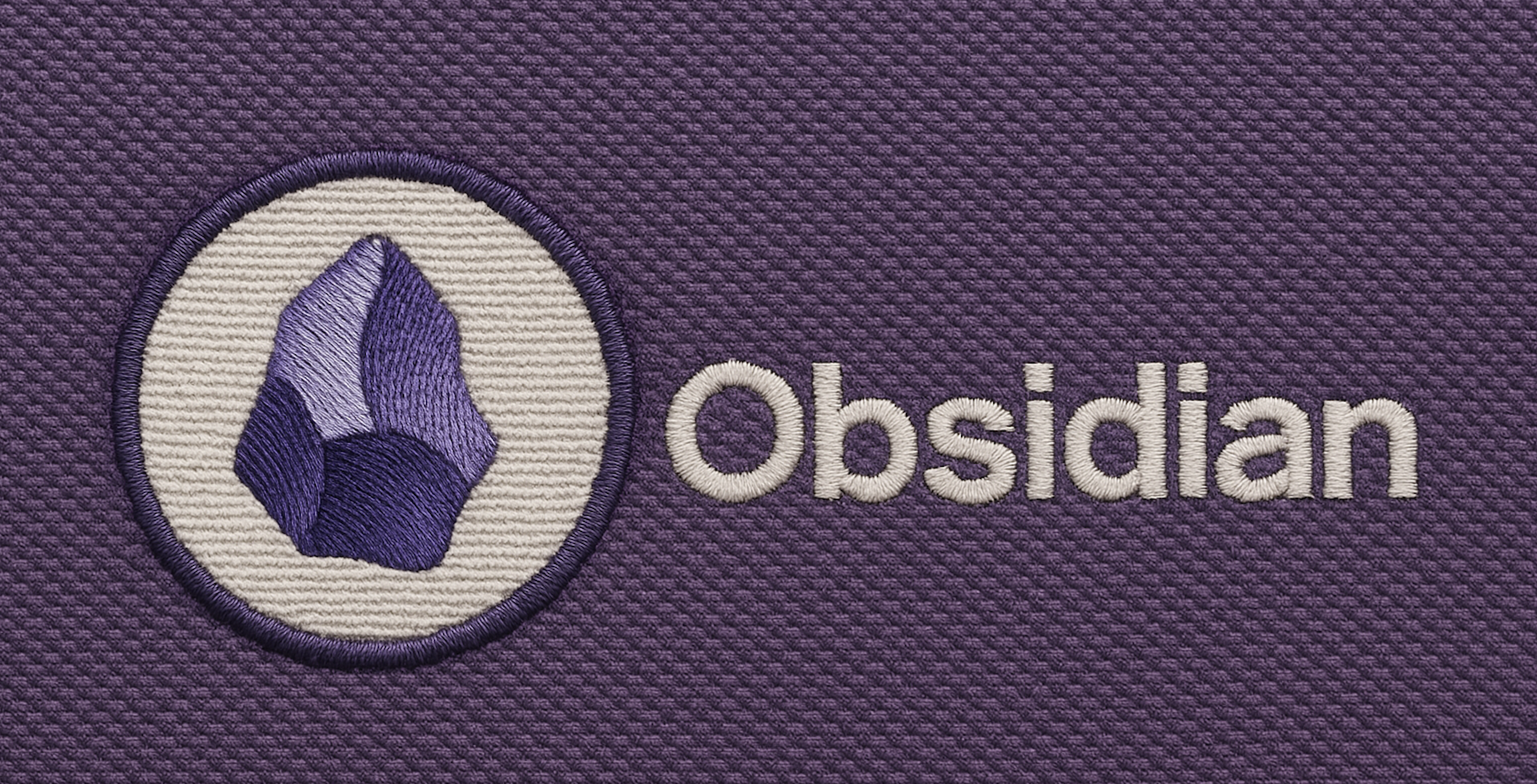 Embroided representation of the obsidian logo